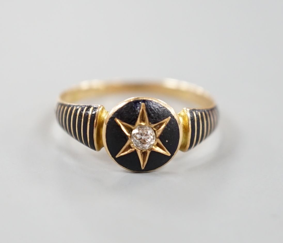 A late Victorian yellow metal, black enamel and diamond set mourning ring, the interior shank with engraved inscription, size Q, gross 2.2 grams